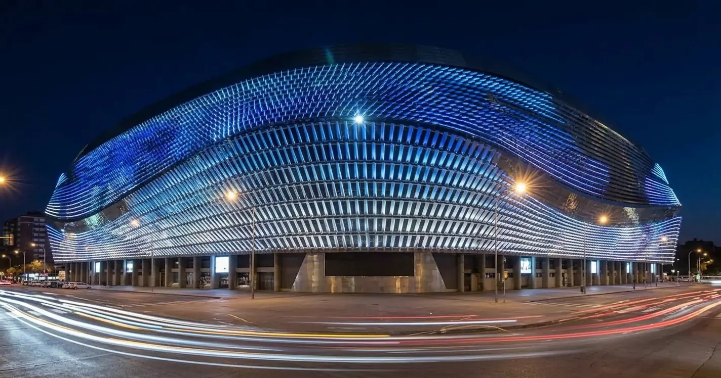 Santiago Bernabéu Stadium's steel facade illuminated at night with its integrated LED lighting system